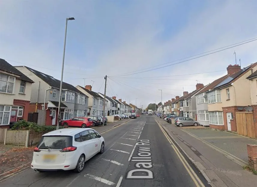 Dallow Road in Luton, lined with parked cars and residential buildings.