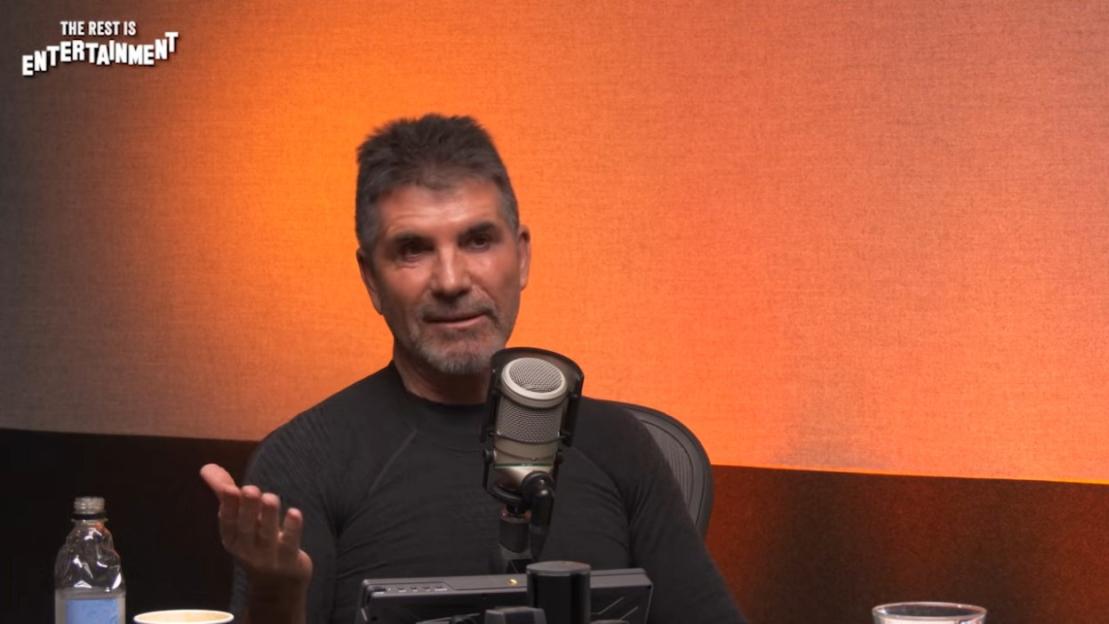 Simon Cowell speaking into a microphone.