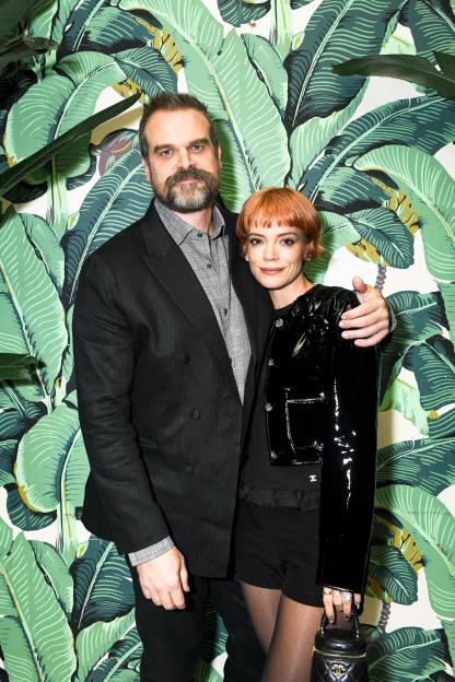 David Harbour and Lily Allen pose against a tropical leaf wallpaper.