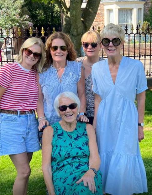 Gloria Stephenson (front) and her daughters pose for a photo.