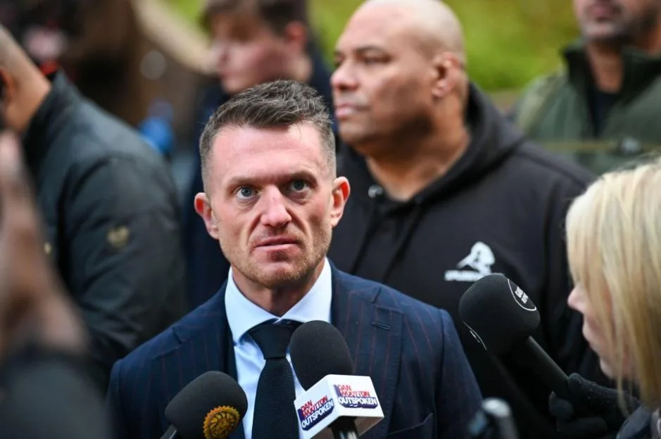 Tommy Robinson arrives at Southwark Crown Court in London, surrounded by supporters and reporters.