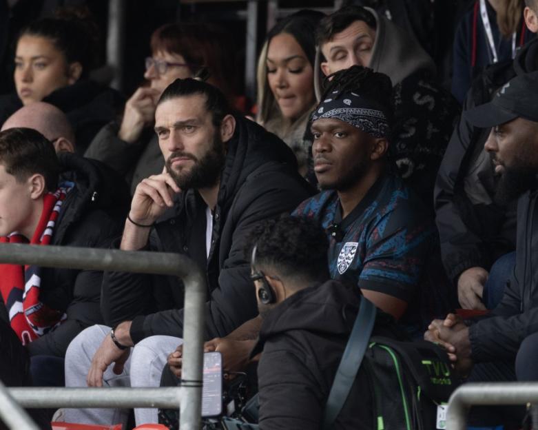 Andy Carroll and KSI watching a Dagenham & Redbridge vs Dorking Wanderers football match.