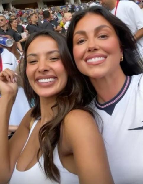 Maya Jama and Olivia Stones smiling at a stadium.