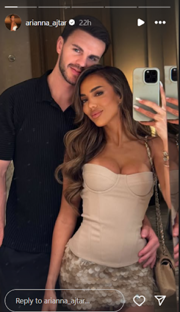 A couple taking a mirror selfie.