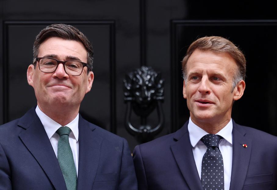 British Prime Minister Andy Burnham and French President Emmanuel Macron pose for the media outside 10 Downing Street.