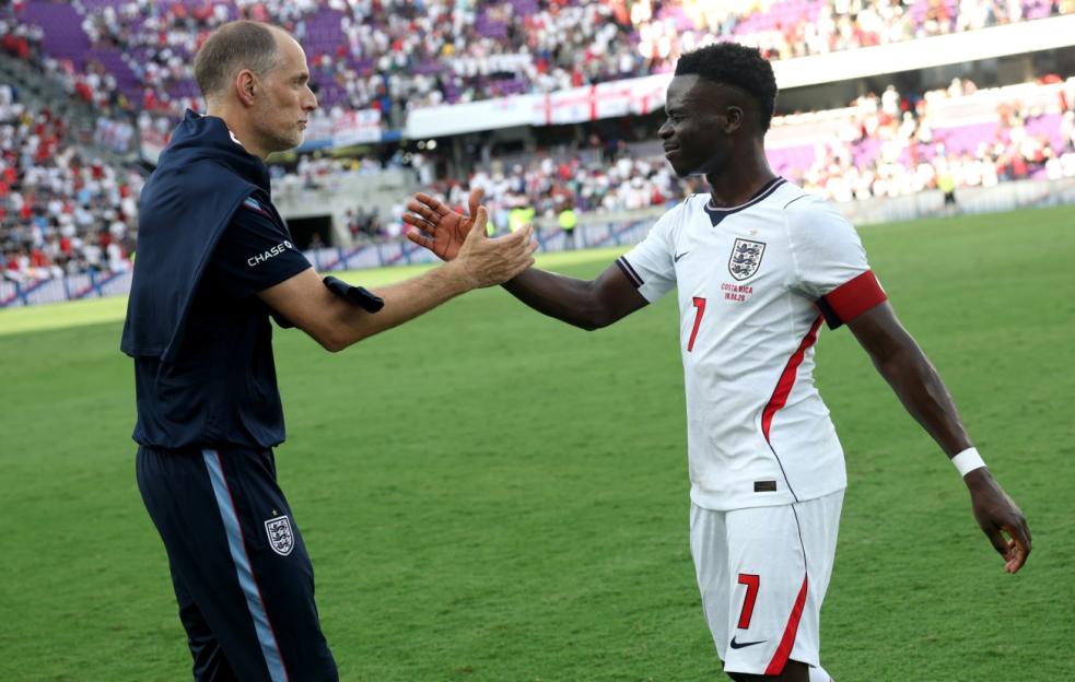 England player Bukayo Saka shaking hands with a coach at an international friendly match against Costa Rica.