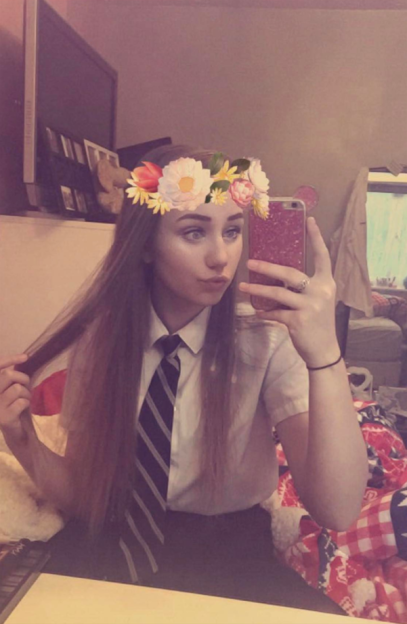 Samantha Clark wearing a flower crown and school uniform.