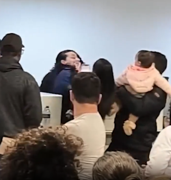 A woman passenger striking a LATAM airline employee at a check-in desk.