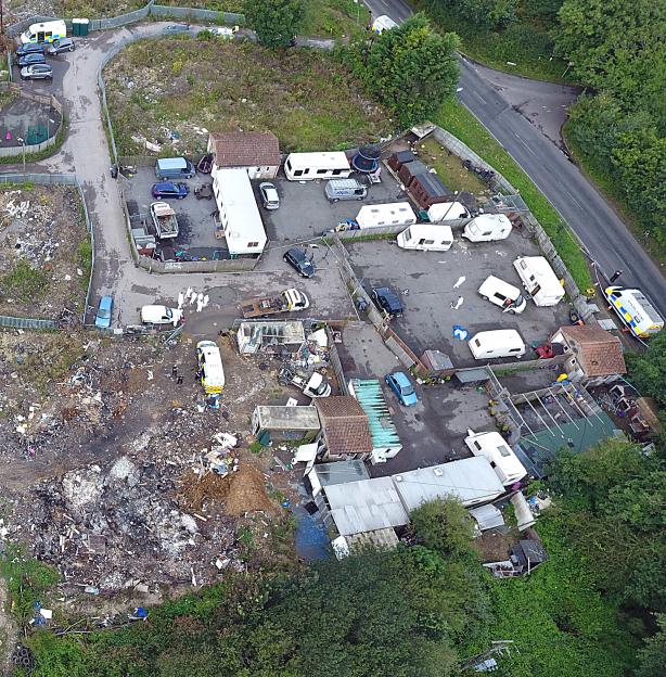 Aerial view of the Four Houses Corner Caravan Site with police presence and evidence markers.