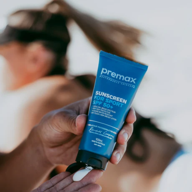 A person squeezing Premex Sunscreen For Sport SPF 50+ onto their hand.