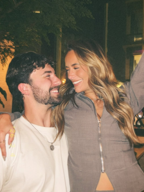 Millie Court smiling at Zac as they stand together.