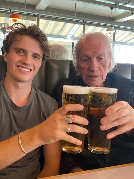 Two men clinking glasses of beer.