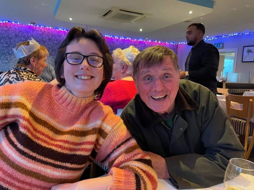 Emma Hayes with her father, Peter Hayes, at a table.