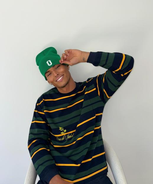 Marlon Lundgren Garcia smiling and wearing a green beanie with a white "O" and a striped long-sleeved shirt.
