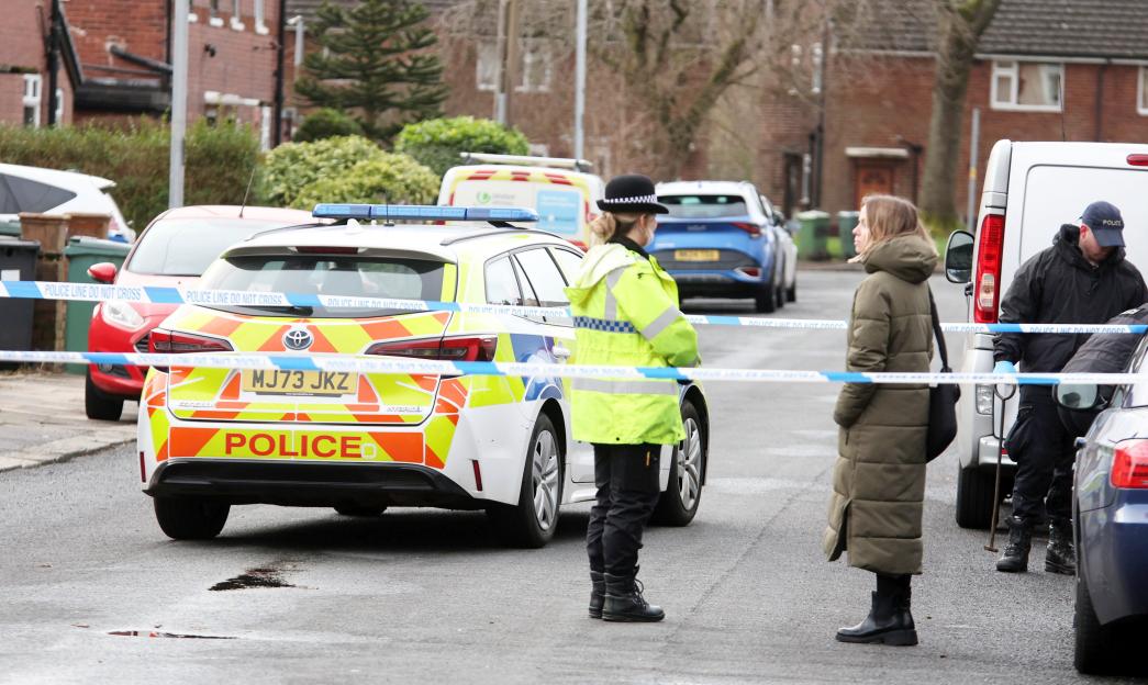 Police and forensic officers investigating a murder on Tarn Drive, Bury, Greater Manchester.