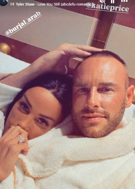 Katie Price and her new husband Lee pose in a "loved up" photo while wearing white bathrobes.