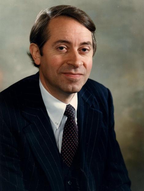 Portrait of Leendert Grijns, father of Andrew Grijns, wearing a pinstripe suit and patterned tie.