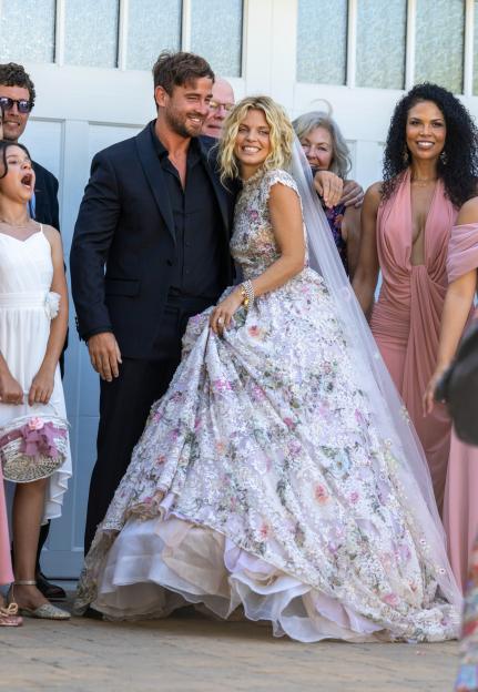 AnnaLynne McCord and Danny Cipriani smiling at their wedding, surrounded by guests.