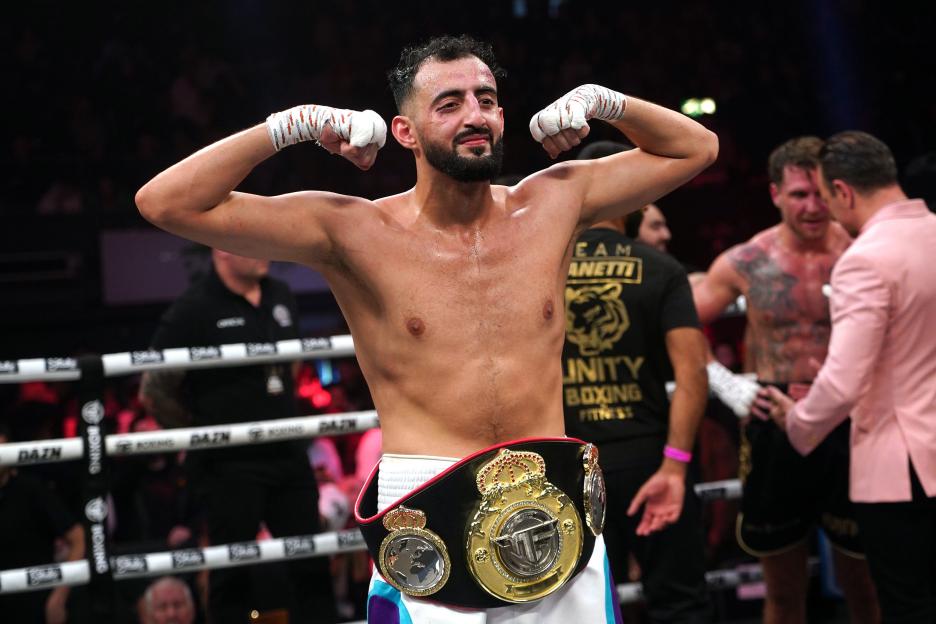 Slim Albaher celebrates winning the light-heavyweight boxing bout.
