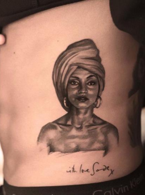 Tattoo of Sade on someone's torso.