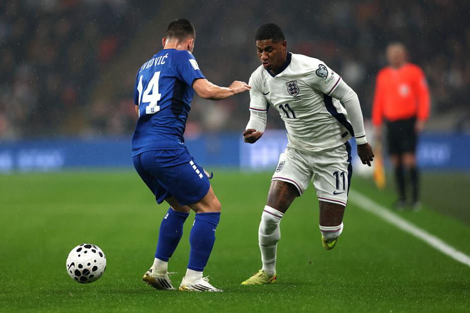 England and Serbia players competing for the ball in a FIFA World Cup 2026 qualifier.