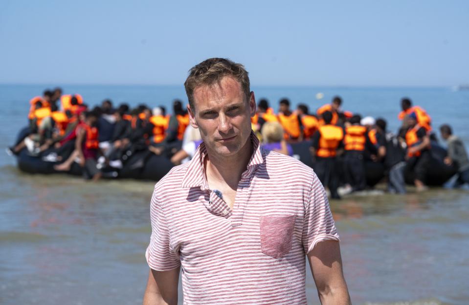 Chris Philp watches migrants in a boat attempting to cross the English Channel.