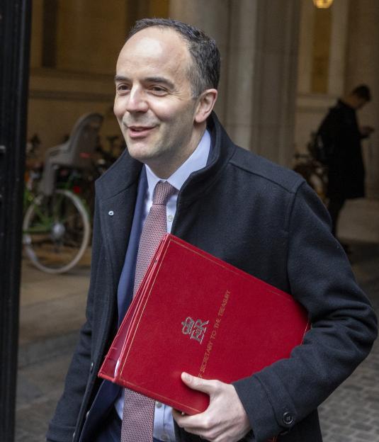 James Murray MP, Chief Secretary to the Treasury, carries a red folder.