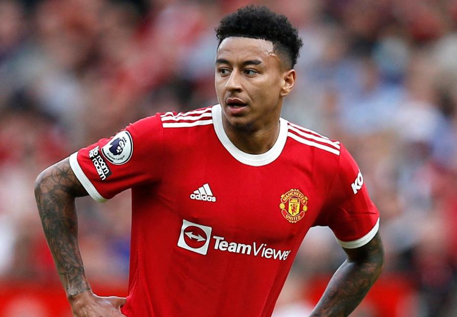 Jesse Lingard wearing a red Manchester United jersey and white shorts.