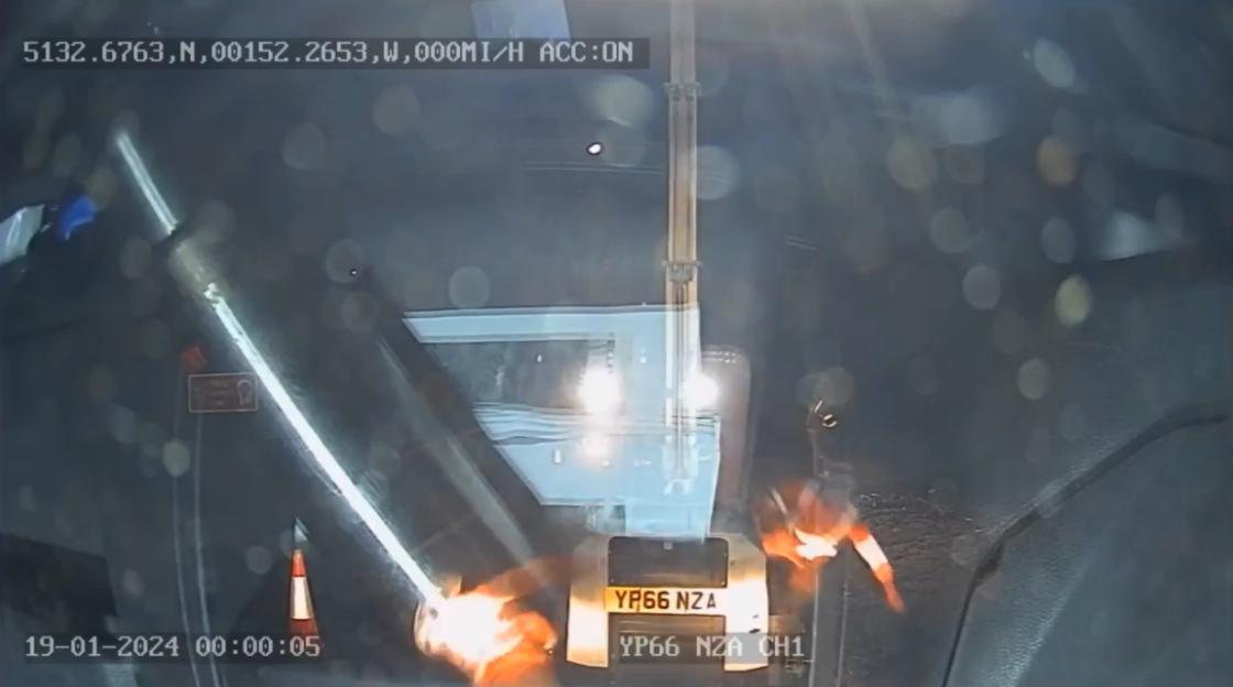 Dashcam footage showing a worker getting an electric shock from an overhead powerline.