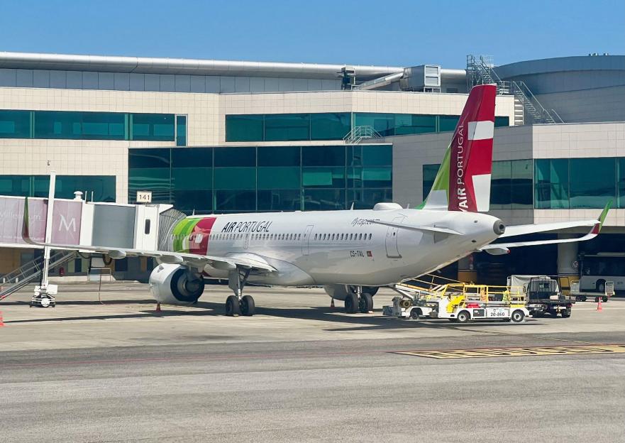 Workers load a TAP Air Portugal jet at Humberto Delgado Airport in Lisbon, Portugal.