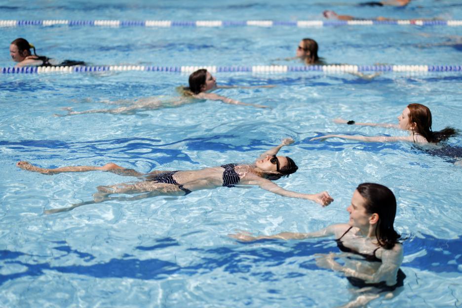 People swim at London Fields Lido outdoor swimming pool during a heatwave in London, Britain.