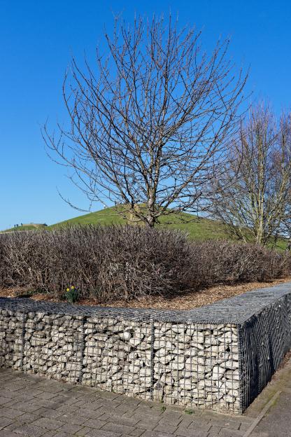 Rubble in a cage forming a wall in Northala Park.