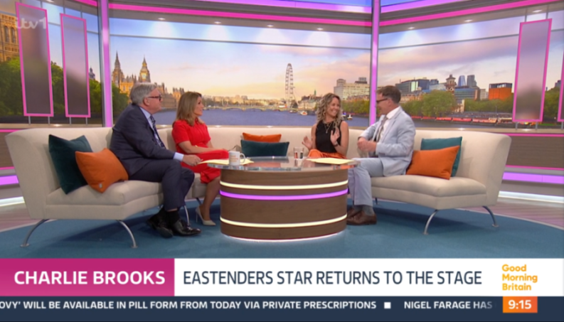 Charlie Brooks with three other people in a talk show setting on Good Morning Britain, discussing her return to the stage.