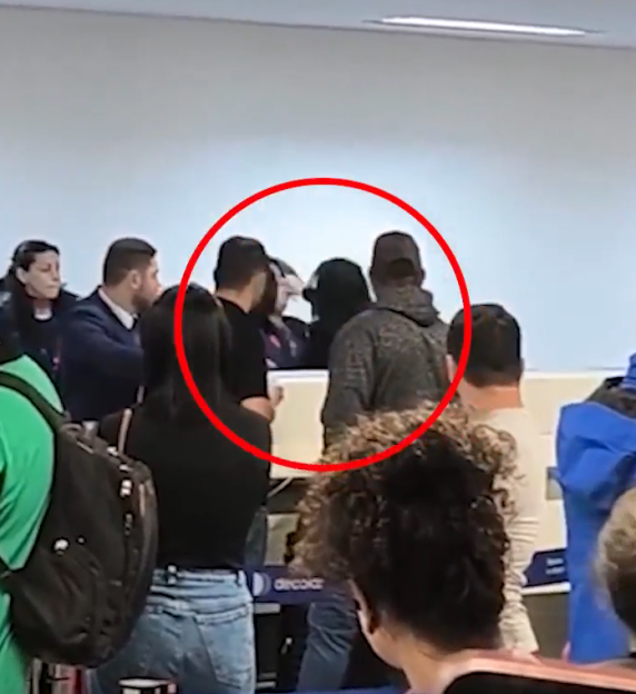 A passenger punching a LATAM airline employee at a check-in desk at Sao Paulo–Guarulhos International Airport.