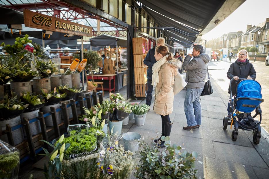 People shopping at The Flowersmith florist in Altrincham market.
