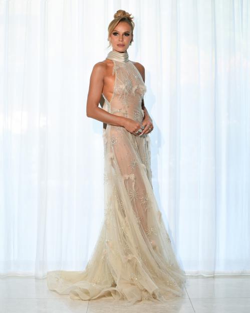 Amanda Holden in a sheer, floor-length, embellished gown with a high neckline.