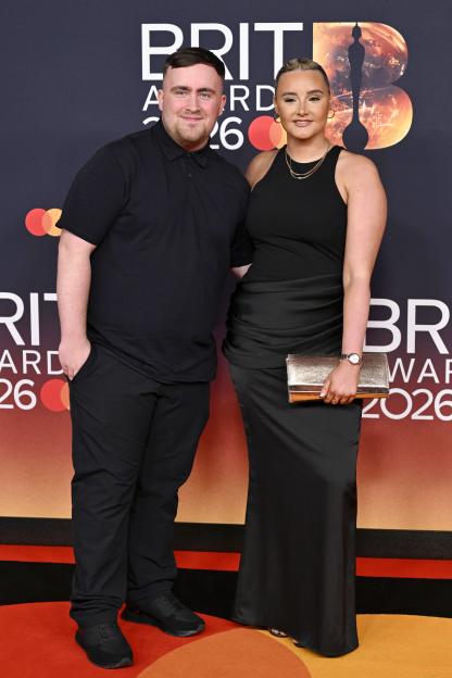 Luke Littler and Faith Millar posing for a photo at The BRIT Awards 2026.
