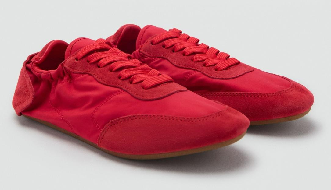 Pair of red athletic shoes with suede accents and red laces.