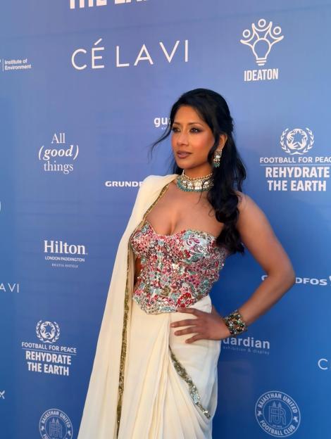 RESHMIN Chowdhury posing in a white and colorful dress.