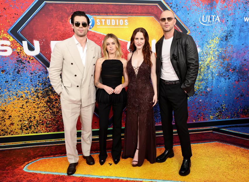 David Corenswet, Milly Alcock, Rachel Brosnahan, and Nicholas Hoult pose on a colorful red carpet for the Supergirl World Premiere.