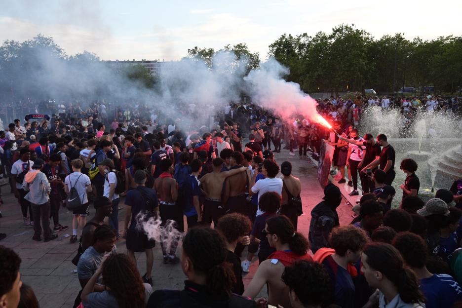 Paris Saint-Germain supporters celebrate their team's championship title in Paris