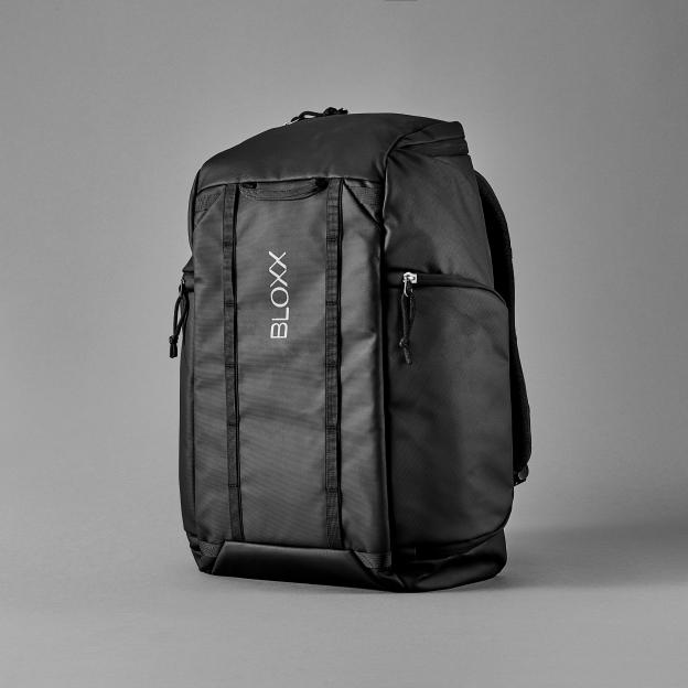 Black BLOXX backpack on a gray background.