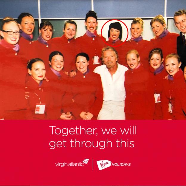 Richard Branson smiling with Virgin Atlantic flight attendants.