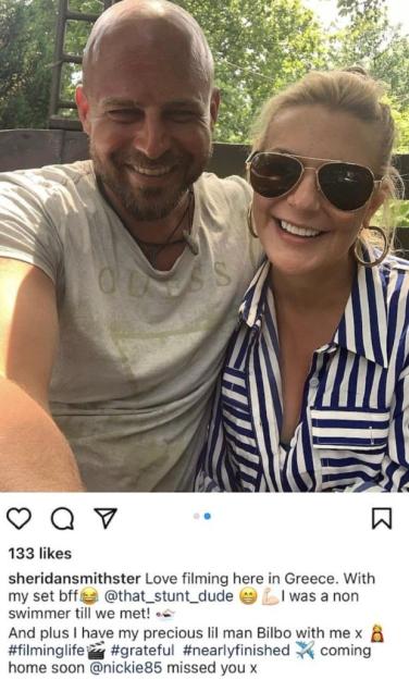 Sheridan Smith and a bald man with a beard, both smiling for the camera.