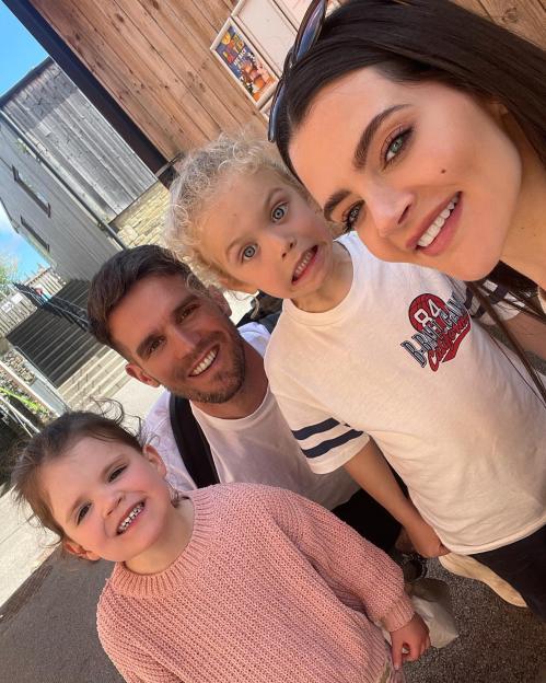 Emma McVey and Gaz Beadle taking a selfie with two children.