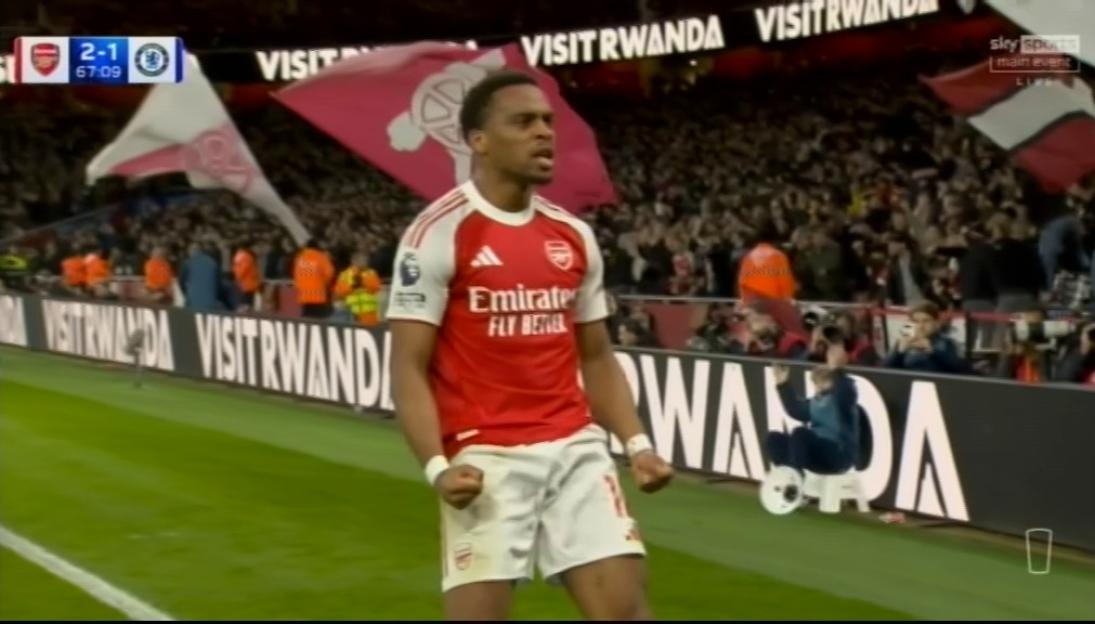 A soccer player in an Arsenal uniform celebrates a goal.