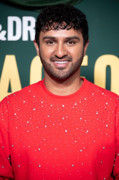 Shabaz Ali smiling at the "Outrageous" UK Premiere.