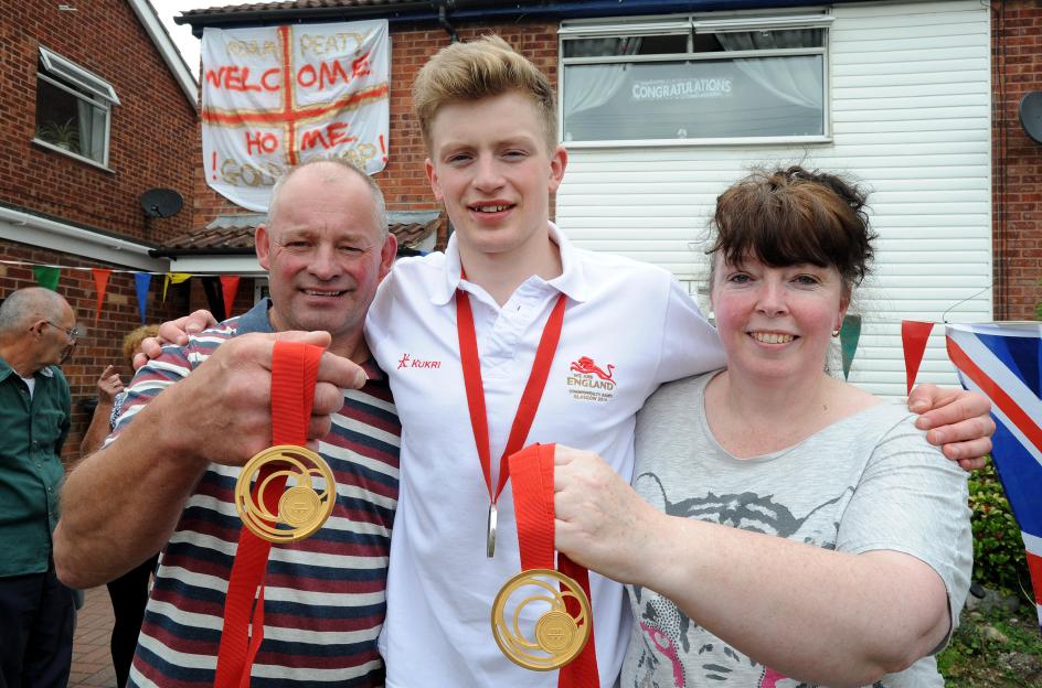 Commonwealth champion Adam Peaty with his parents, Mark and Caroline Peaty, after returning home.