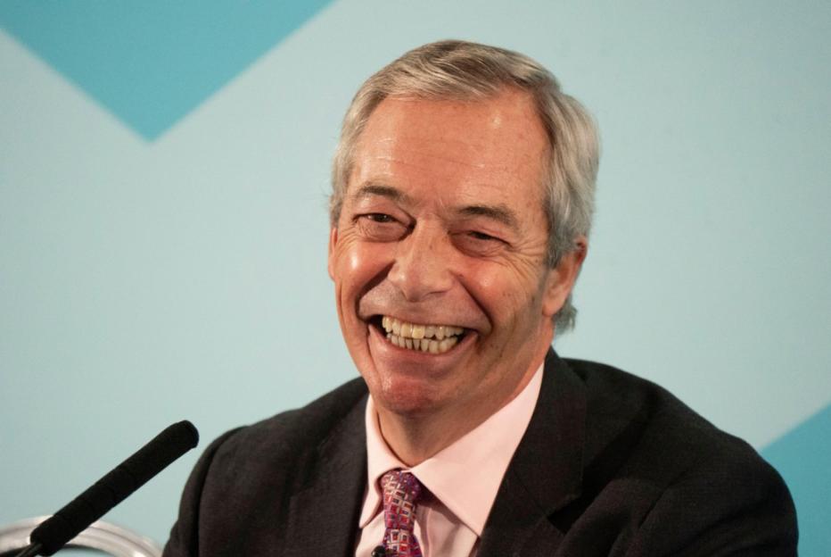 Nigel Farage laughing at a press conference.