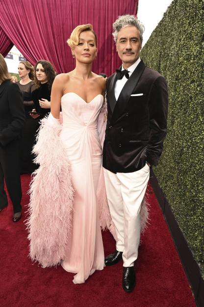 Rita Ora and Taika Waititi pose on the red carpet at the 76th Emmy Awards.